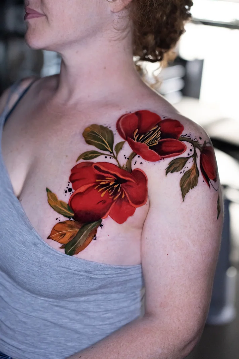 Red floral shoulder tattoo by Kristina Vishar